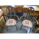 A pair of Ercol Golden Dawn elm and beech swan back Quaker elbow chairs
