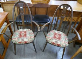 A pair of Ercol Golden Dawn elm and beech swan back Quaker elbow chairs