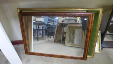 Two large framed prints and a carved oak mirror