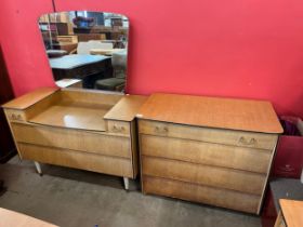 A teak dressing table and matching chest of drawers