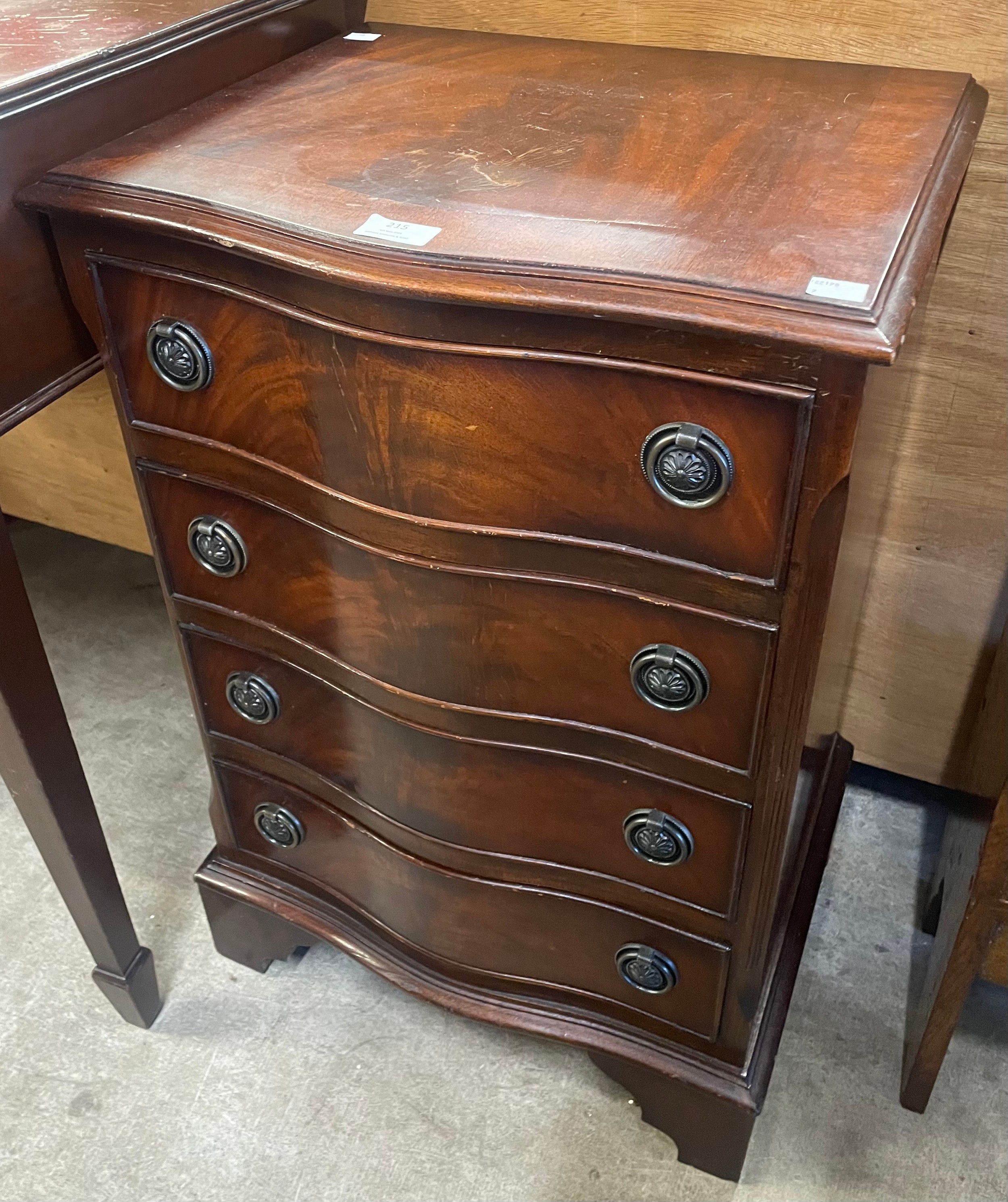 A small George III style mahogany serpentine chest of drawers