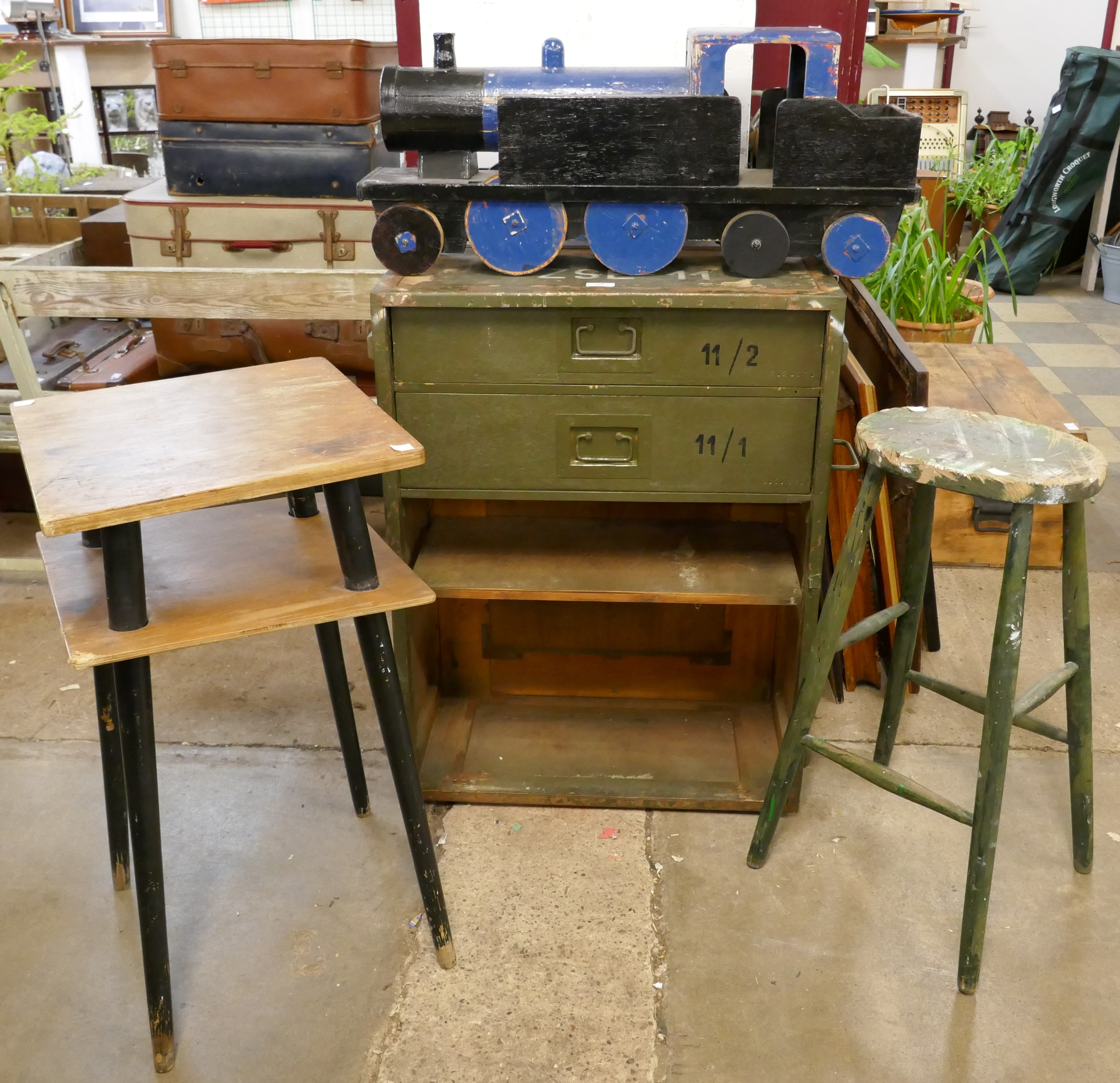 A military style chest, a pine stool, a teak occasional table and a woden toy train