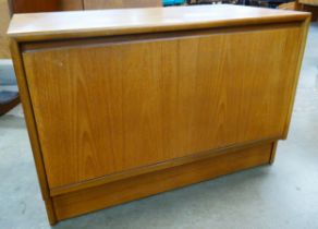 A small teak fall front cabinet