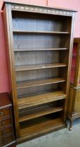 A tall Ercol Golden Dawn ash open bookcase