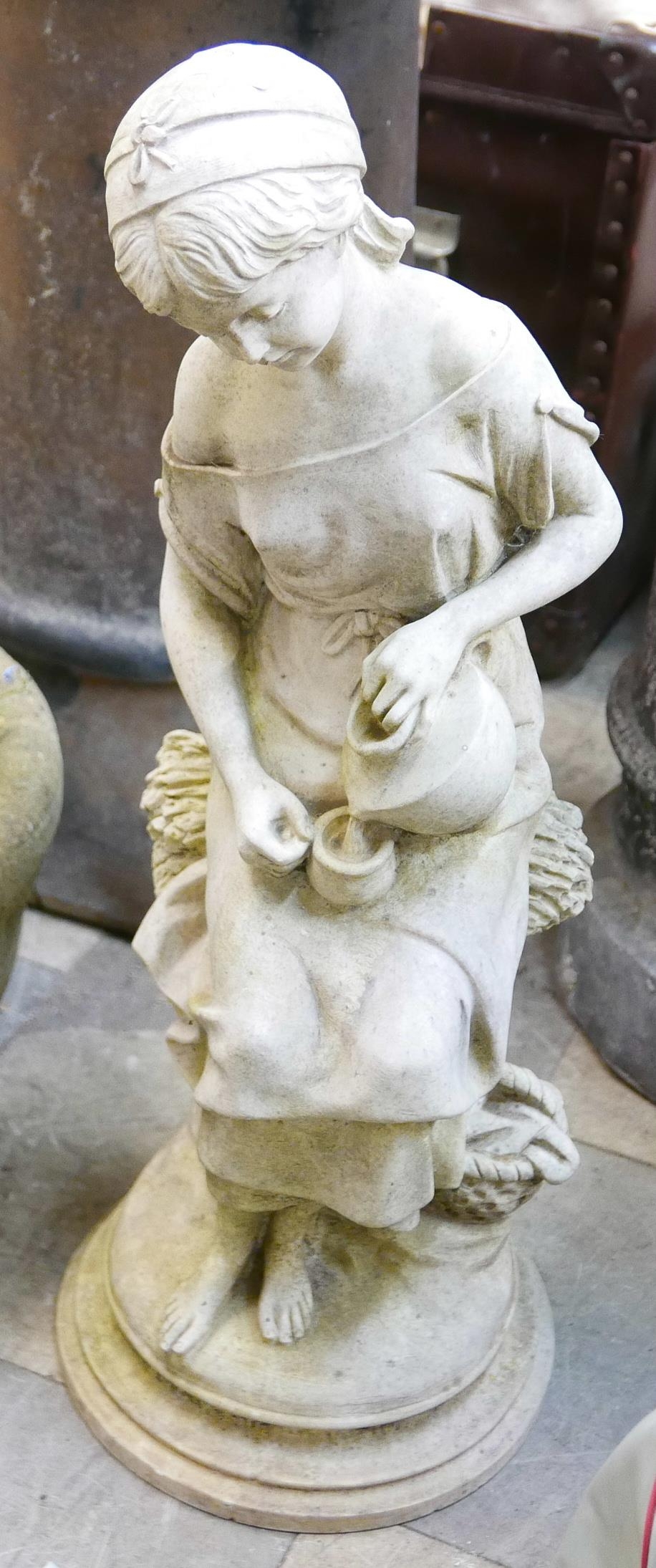 A concrete garden figure of a girl