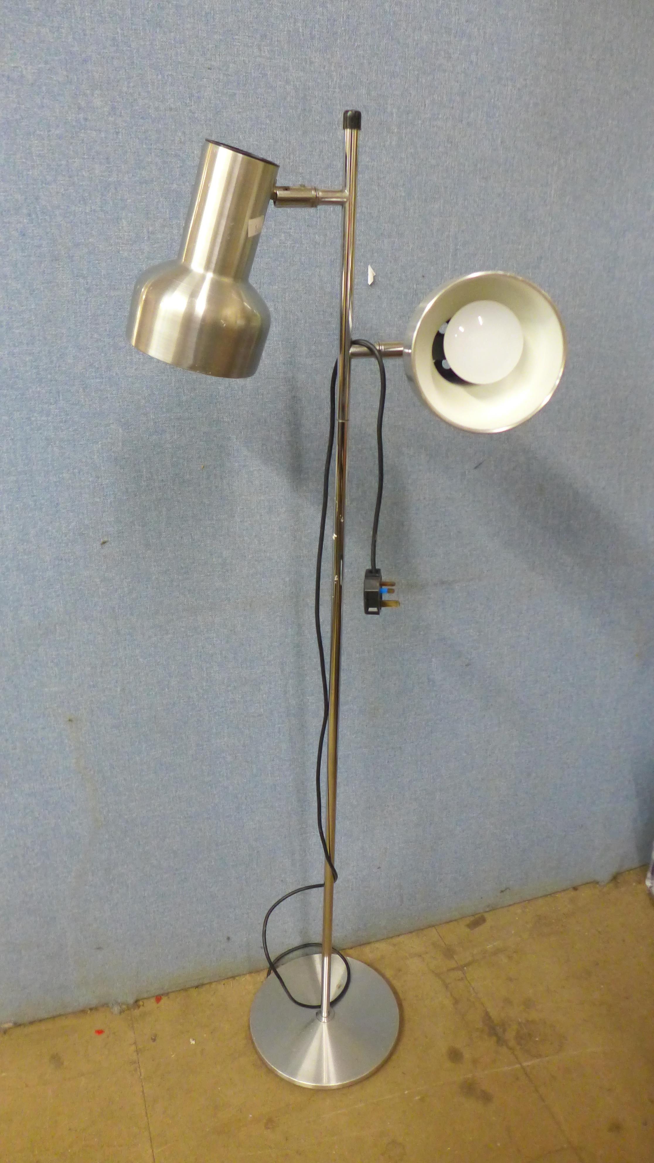 A chrome floor standing spotlight lamp