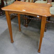 An Arts and Crafts oak paddle foot occasional table