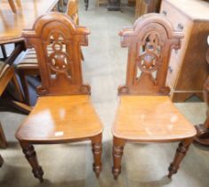 A pair of Victorian mahogany hall chairs