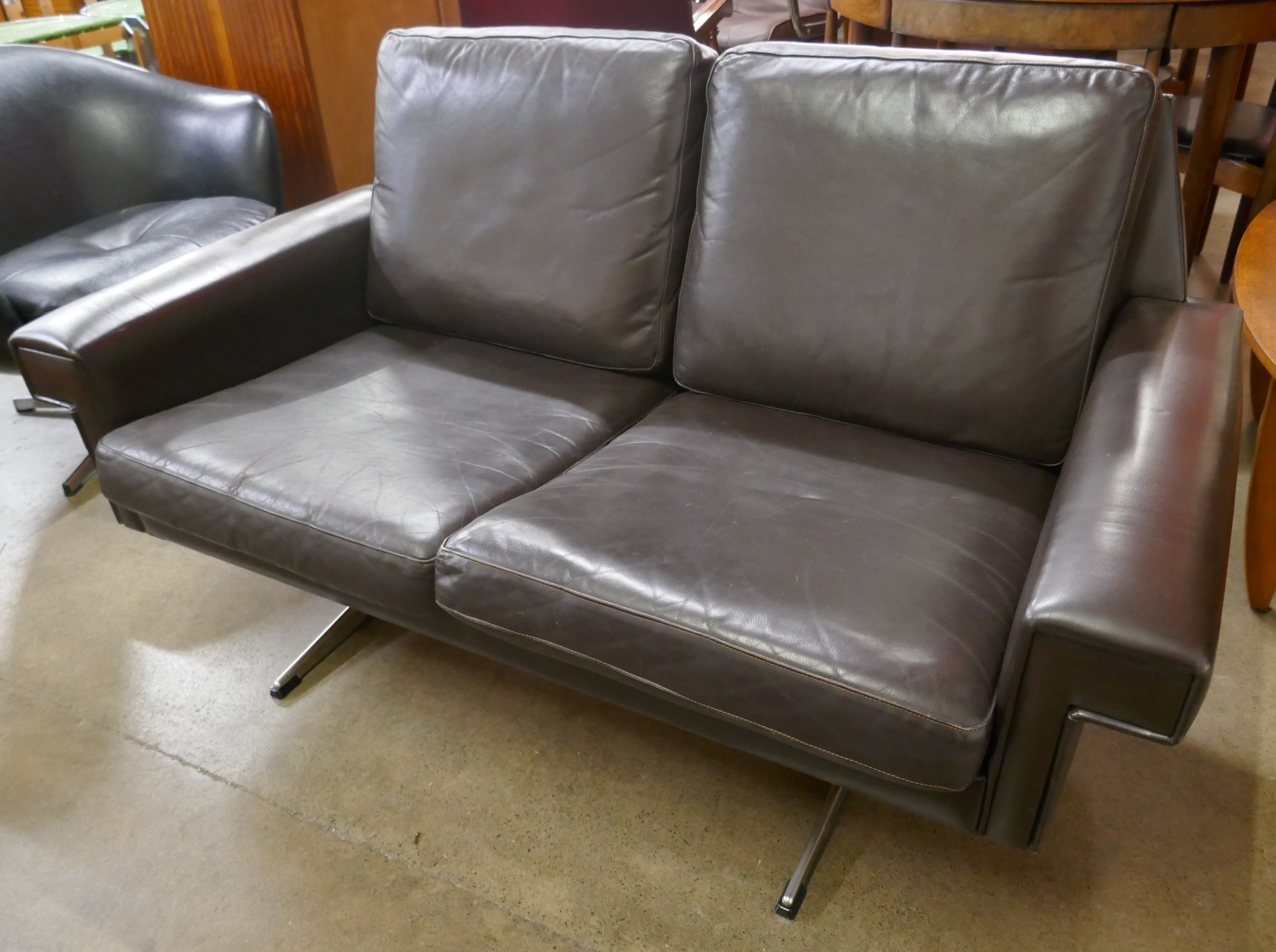 A Danish Stouby black leather two seater sofa