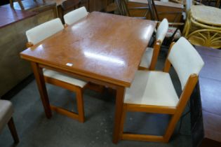 A teak extending dining table and four chairs