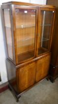 A Queen Anne style figured walnut display cabinet