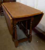 An oak drop-leaf table