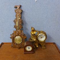 A carved oak barometer and two clocks