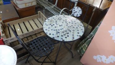 A mosaic topped garden table and two chairs
