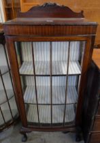An Edward VII mahogany single door bow front display cabinet
