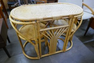 A bamboo and rattan table and two chairs