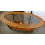 A teak oval coffee table