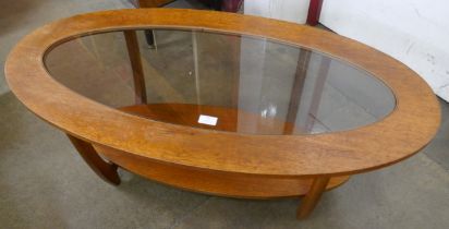 A teak oval coffee table