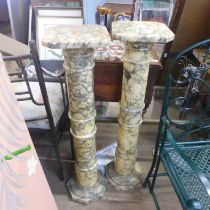 A pair of marble jardiniere stands