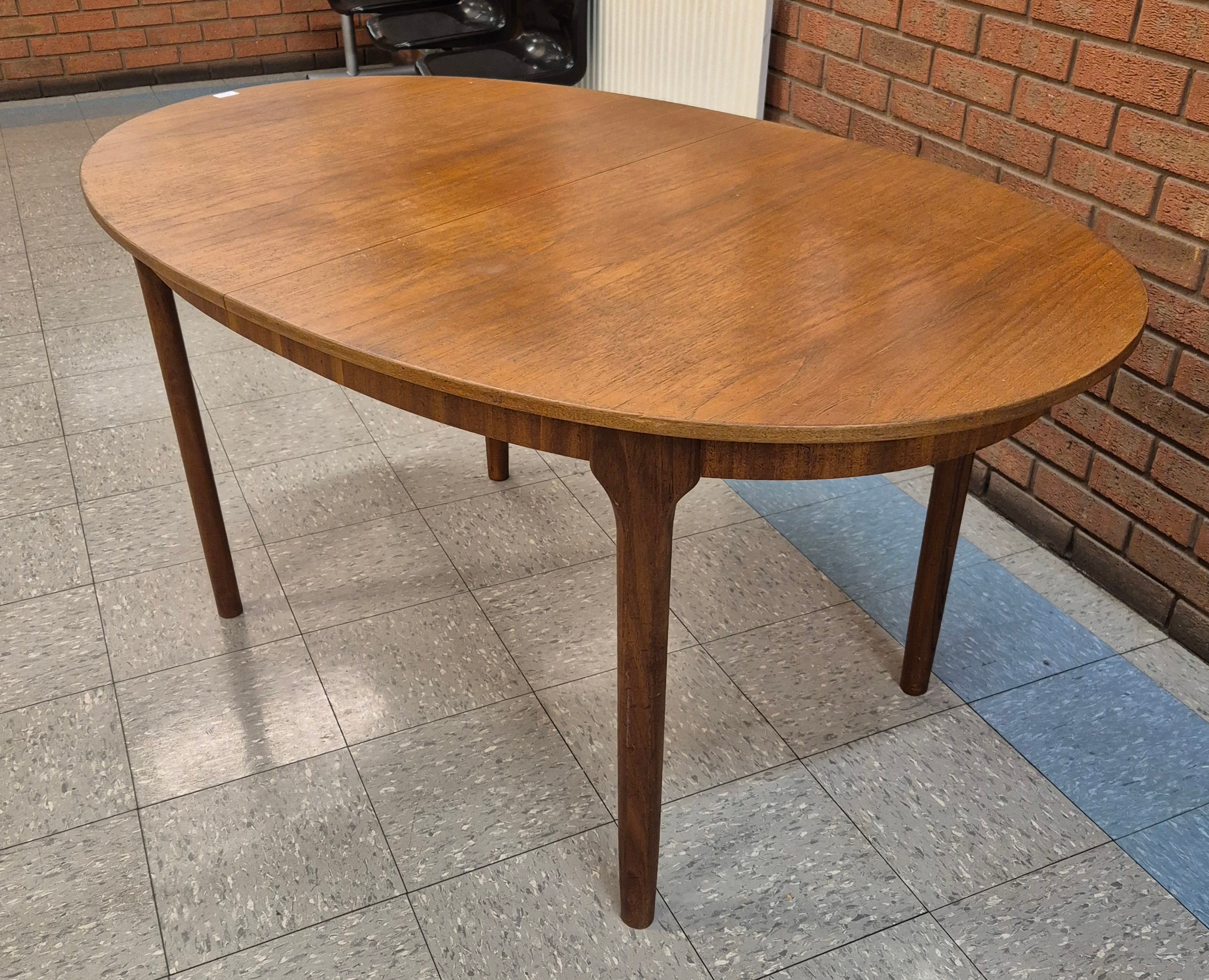 A McIntosh oval teak extending dining table