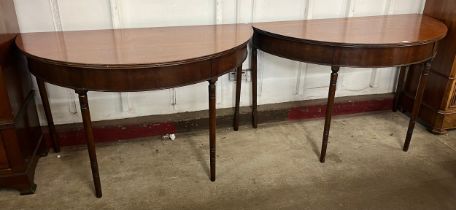 A pair of George IV mahogany demi-lune console tables