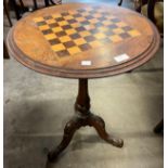 A Victorian inlaid walnut tripod games table