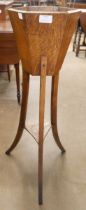 An Arts and Crafts oak jardiniere stand