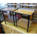 A pair of teak and black leg side tables