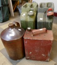 Two Jerry cans, a stoneware flagon and one other