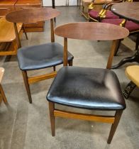 A pair of Danish teak and black vinyl chairs
