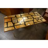 A Denmor of London gold coloured glass and tubular metal coffee table