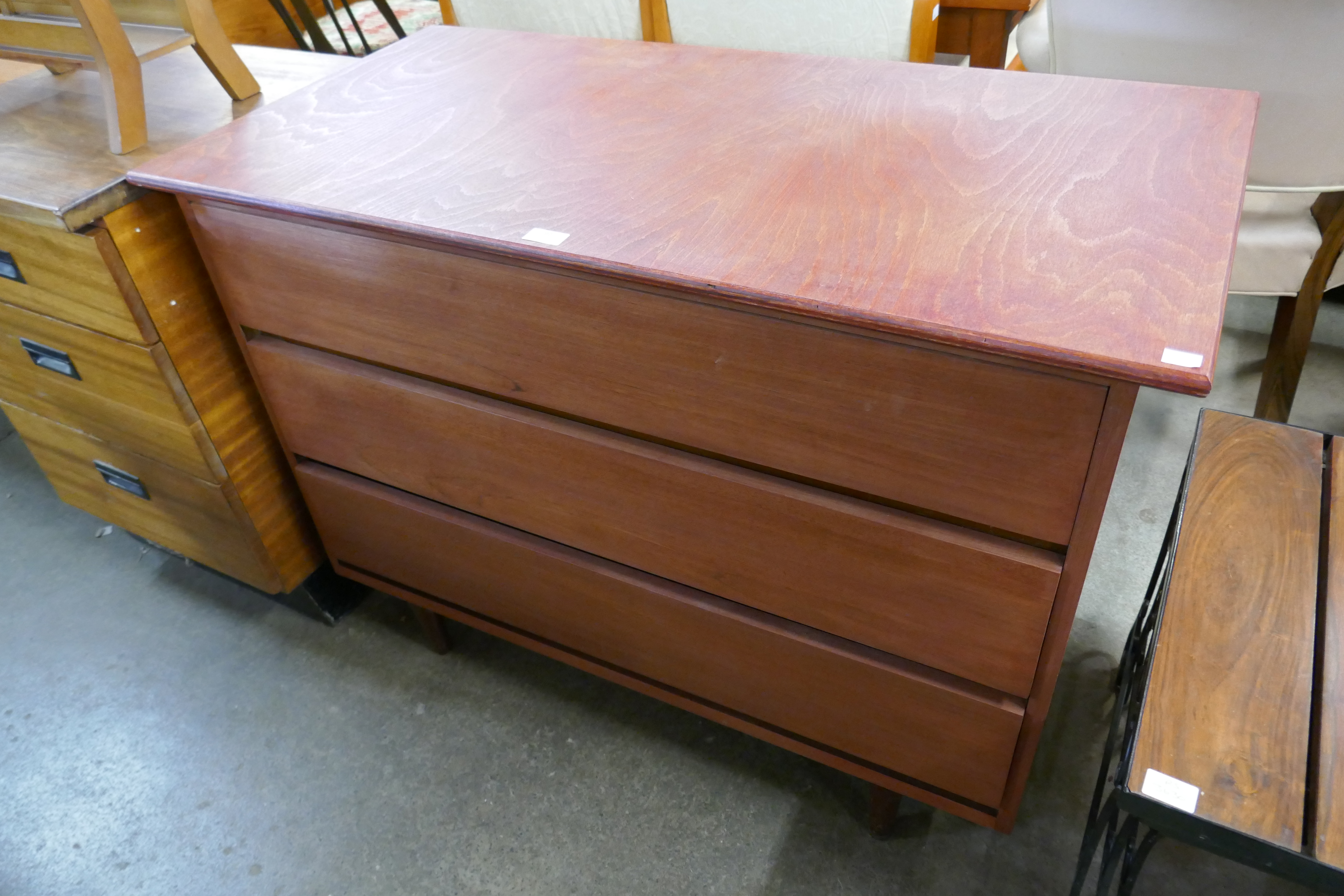 A teak chest of drawers