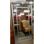 A large French style silver effect framed mirror