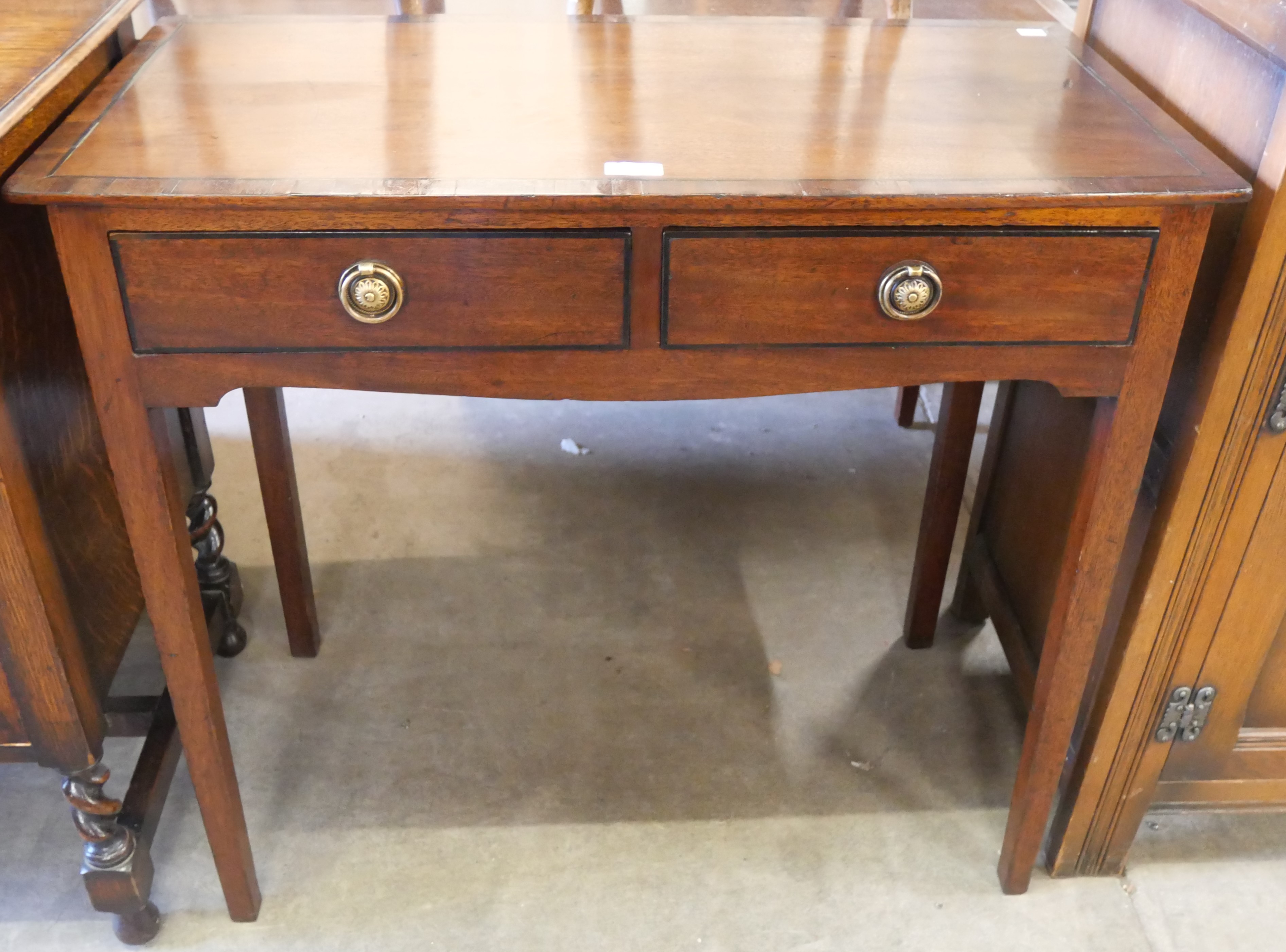 A George III inlaid mahogany two drawer side table