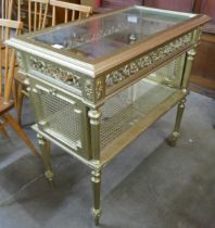 A French Louis XIV style giltwood, bergere and glass topped two tier etagere