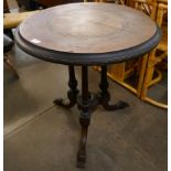 A Victorian Aesthetic Movement marquetry inlaid figured walnut circular tilt top centre table