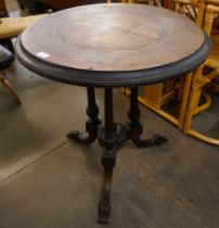 A Victorian Aesthetic Movement marquetry inlaid figured walnut circular tilt top centre table