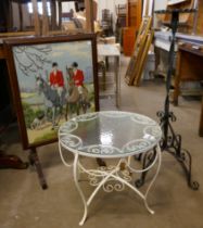 A wrought iron and glass topped table, a tapestry firescreen and a metal plant stand