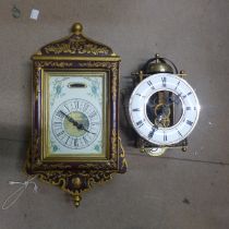 A Maltese wall hanging clock and a hanging skeleton clock