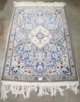 A small eastern cream ground rug