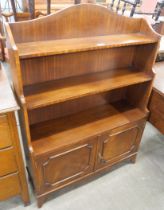 A mahogany two door open bookcase