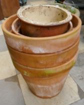 Seven terracotta plant pots