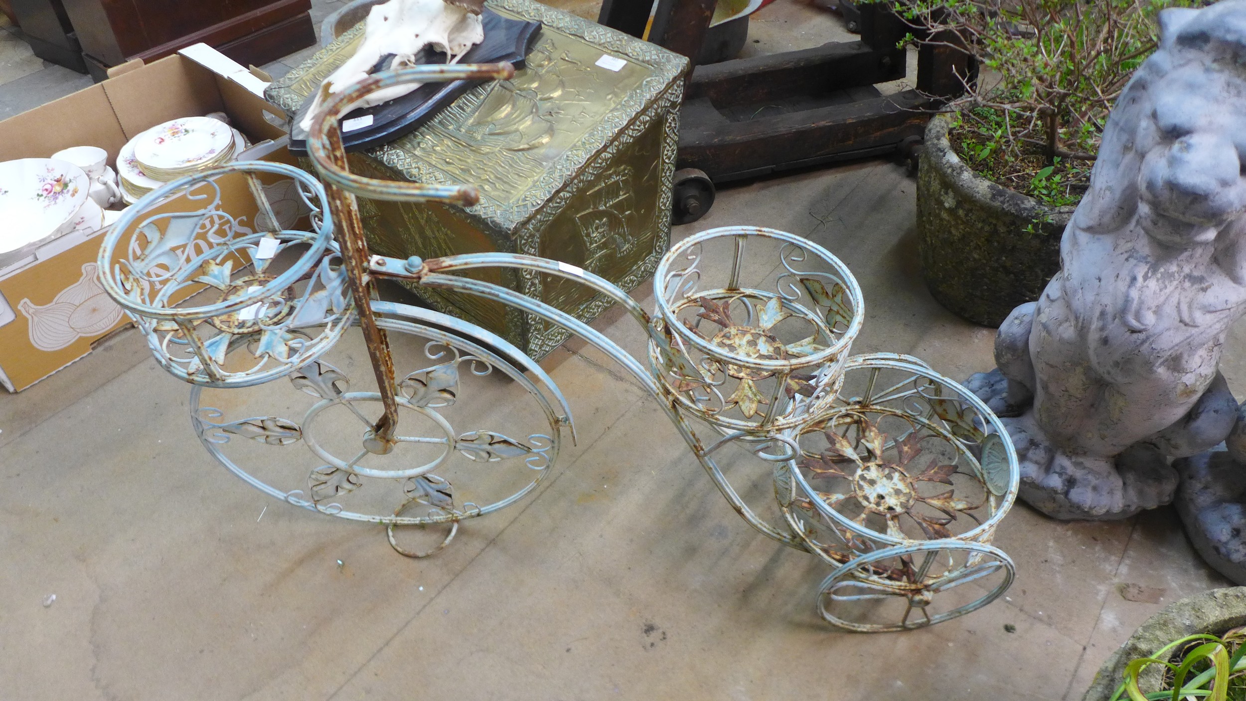 A French style metal tricycle shaped garden planter