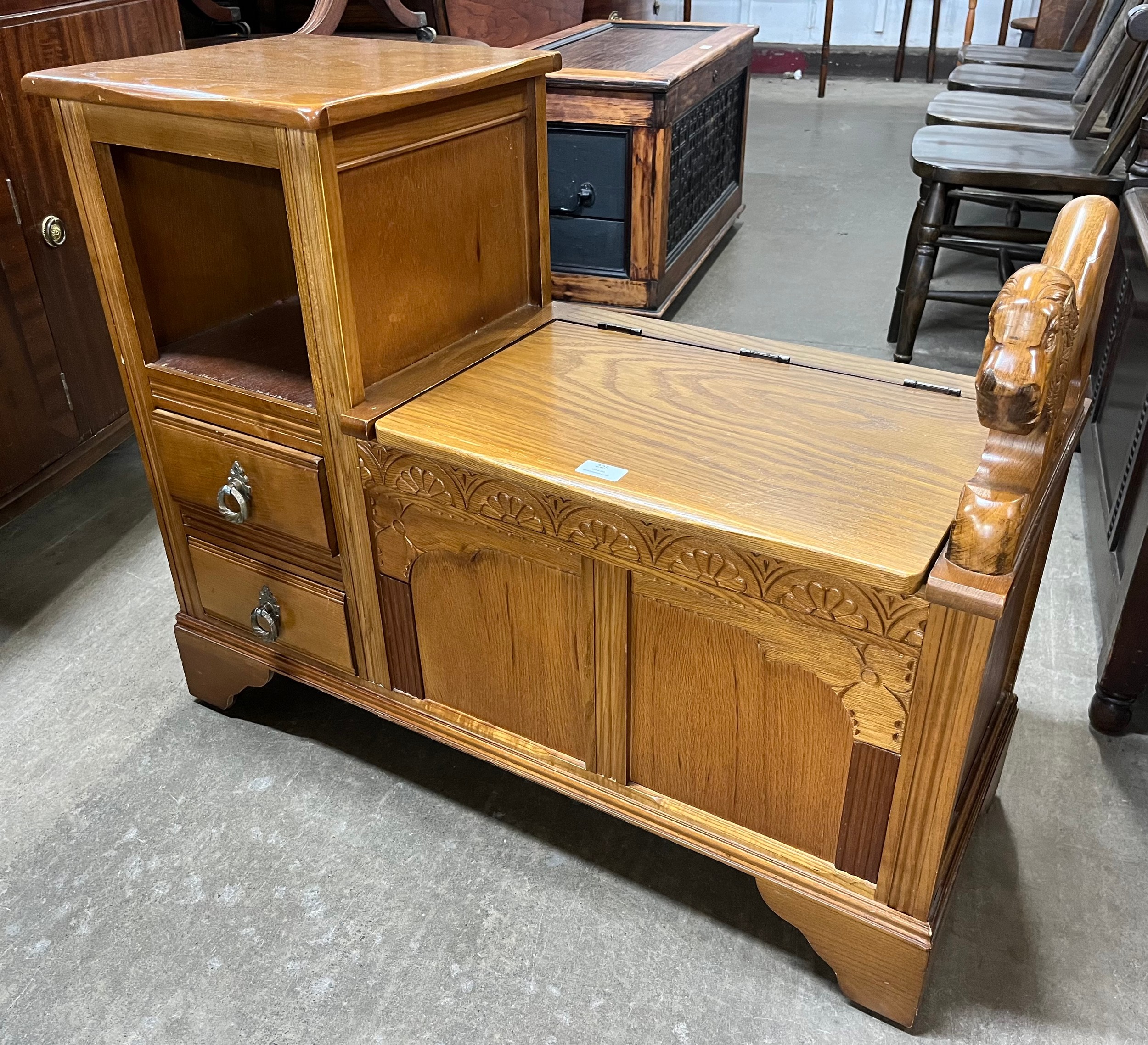 A carved oak telephone seat