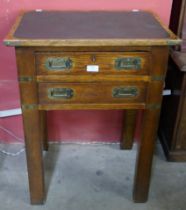 A Victorian campaign style oak, brass mounted and green leather topped two drawer side table