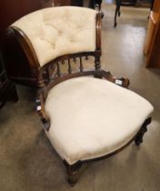 A Victorian carved walnut and fabric upholstered lady's chair