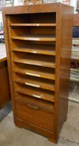 An oak tambour front filing cabinet
