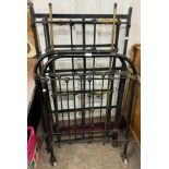 A Victorian wrought iron and brass cot