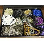 A collection of costume jewellery, beads, chains, etc., in display box