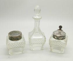 A three piece condiment set, two with silver tops, lacking stand